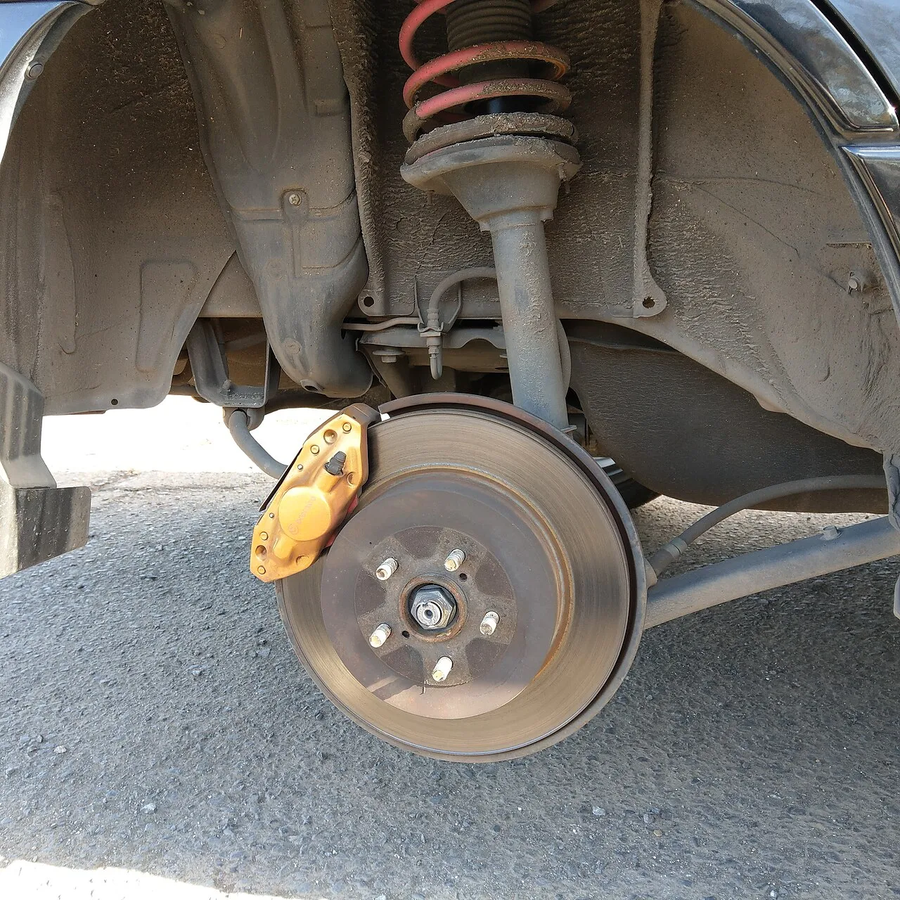 Brake caliper being serviced on a vehicle during mobile brake repair in San Antonio