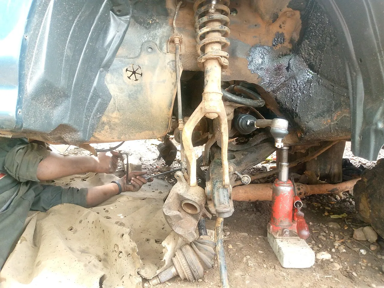Mobile brake repair technician servicing a vehicle in a driveway in San Antonio